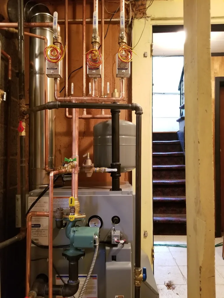 Hot water heating system boiler with zone valves and copper piping installed by Absolute Precision in Bergen County, NJ