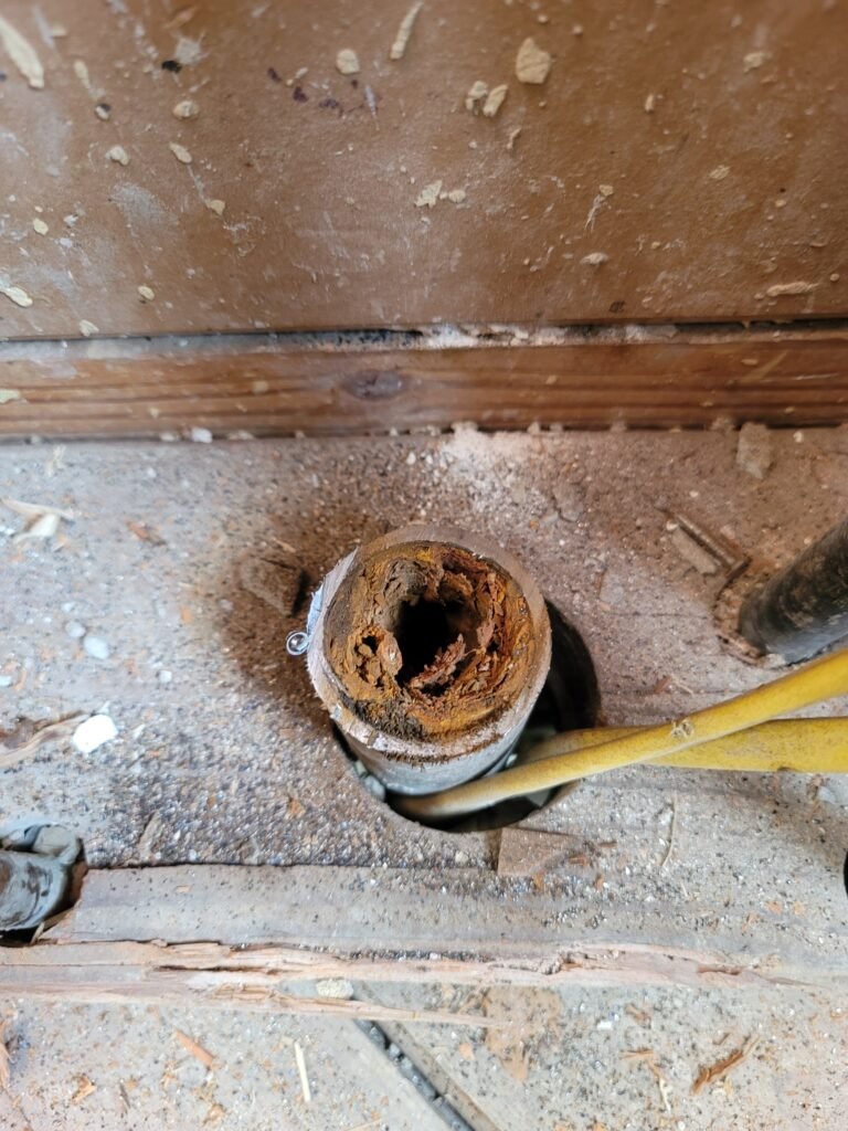 Old drain pipe needing drain cleaning, its inside nearly closed off by rust and scale