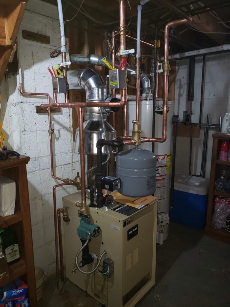Weil-McLain hot water boiler with expansion tank and copper piping installed by Absolute Precision, serving Hasbrouck Heights, NJ