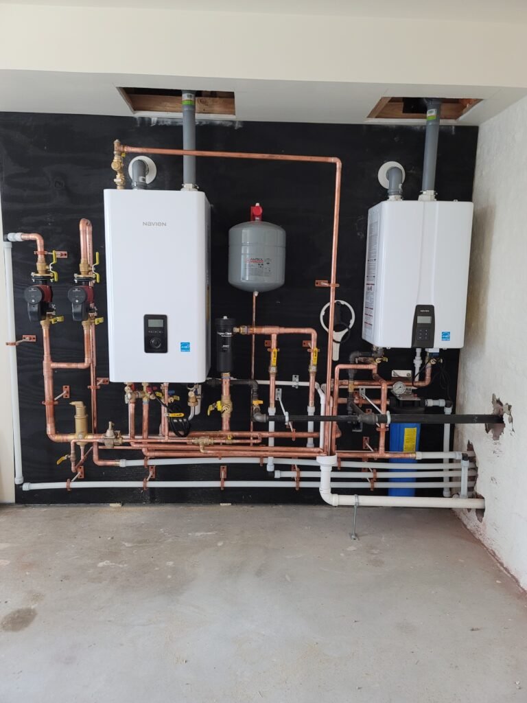 Navien NFC combi boiler and Navien NPE with copper piping installed by Absolute Precision