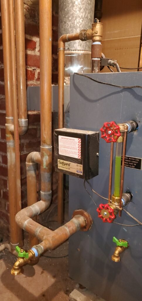 Steam boiler maintenance: low water cut-off, gauge glass and piping on a steam boiler