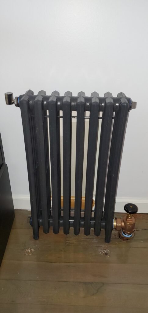Cast iron steam radiator with a brass steam valve in a Bergen County home