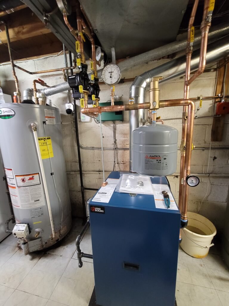 Utica hot water boiler with expansion tank and copper piping installed by Absolute Precision